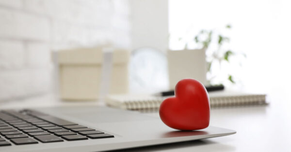Heart and laptop - personal values at work concept